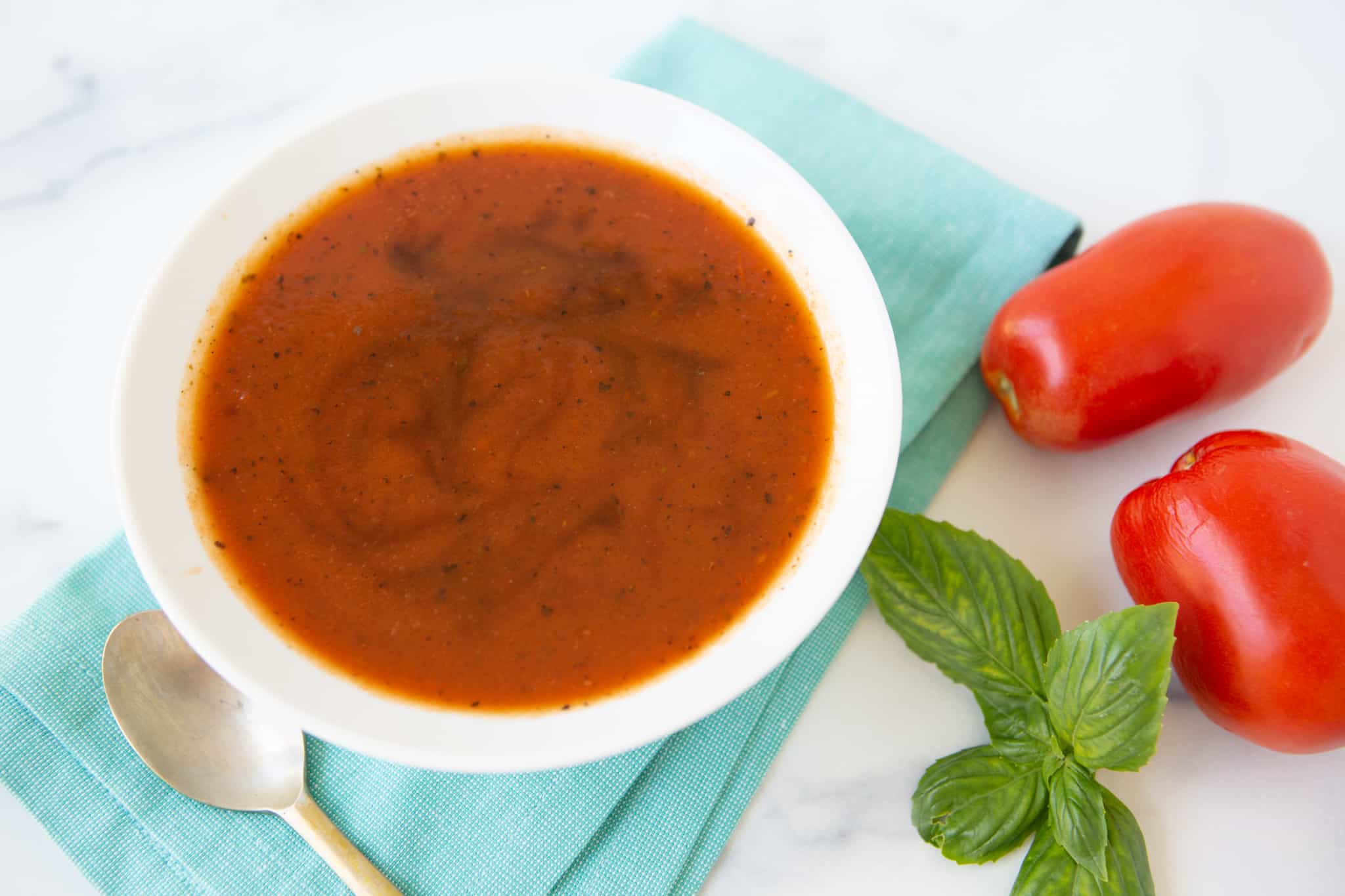 tomato soup garnished with a swirl of balsamic vinegar