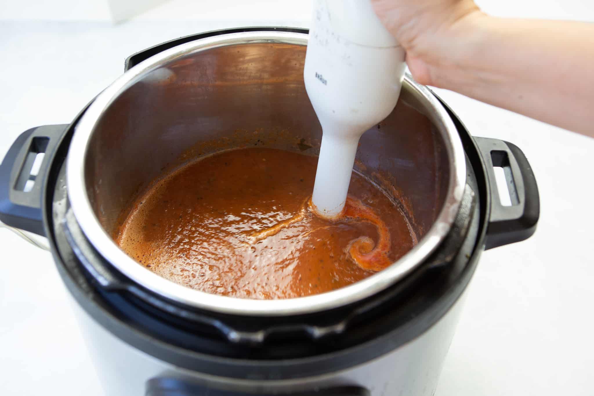 Immersion blender in the tomato soup