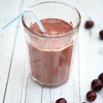 chocolate cherry recovery smoothie with a straw