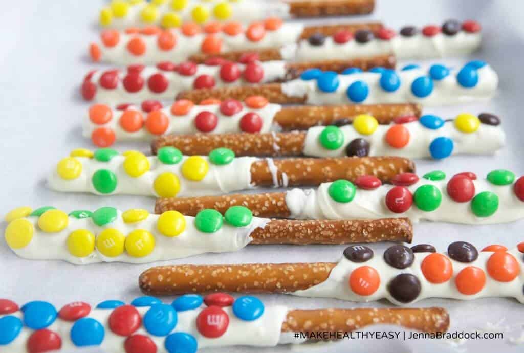 These White Chocolate Dipped Pretzel Rods are so easy that you will never need to buy a sweet treat for a party or special gift again. Serve them open in a mason jar or individually wrapped for a reasonable, beautiful dessert. #MakeHealthyEasy via @JBraddockRD http://JennaBraddock.com