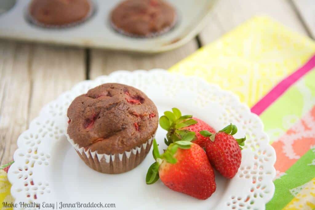 chocolate strawberry breakfast muffin on a plate with strawberries on the side