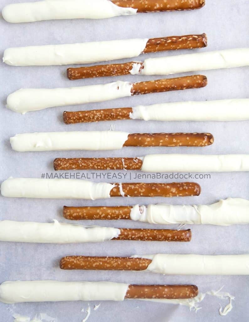 These White Chocolate Dipped Pretzel Rods are so easy that you will never need to buy a sweet treat for a party or special gift again. Serve them open in a mason jar or individually wrapped for a reasonable, beautiful dessert. #MakeHealthyEasy via @JBraddockRD http://JennaBraddock.com