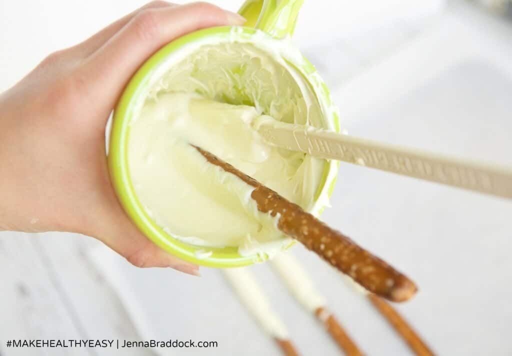 These White Chocolate Dipped Pretzel Rods are so easy that you will never need to buy a sweet treat for a party or special gift again. Serve them open in a mason jar or individually wrapped for a reasonable, beautiful dessert. #MakeHealthyEasy via @JBraddockRD http://JennaBraddock.com