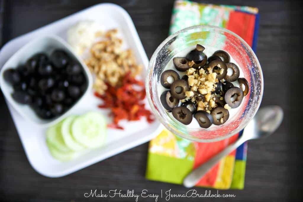 Savory Mediterranean Yogurt Parfait - A unique twist on a yogurt parfait, perfect for an easy lunch. Olives, cucumber, parsley, sun dried tomatoes and garlic bring together the flavors of the Mediterranean in this healthy and delicious dish. #MakeHealthyEasy via @JBraddockRD http://JennaBraddock.com