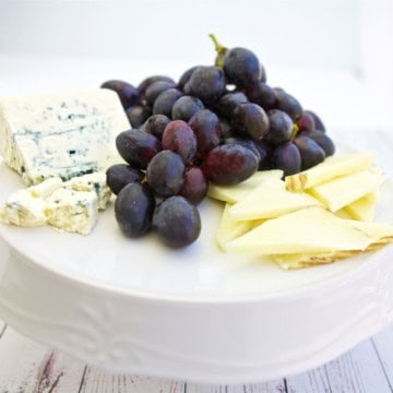 easy Cheese Platter Ideas with black grapes, red grapes, and green grapes