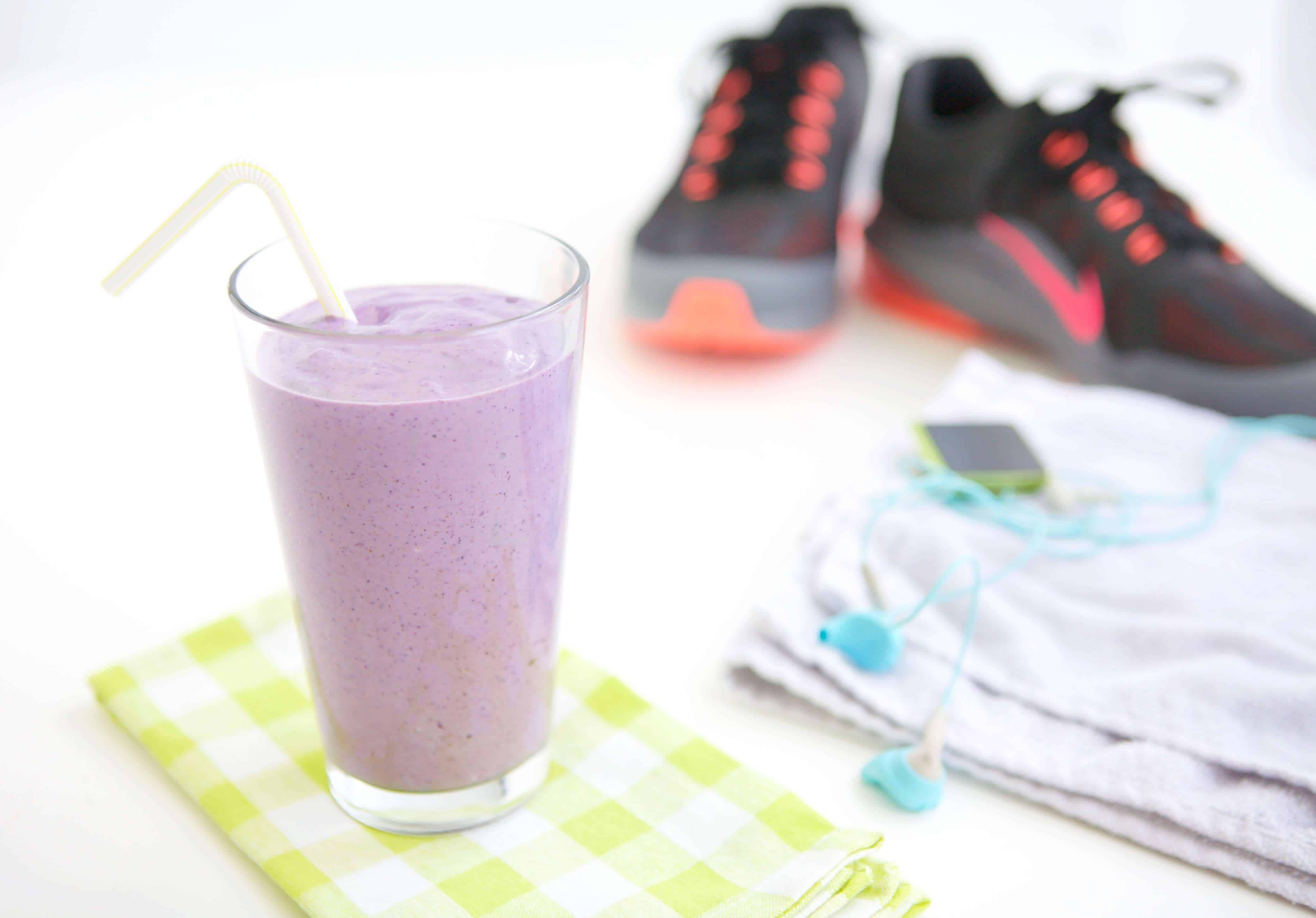 blueberry smoothie for athletes next to a pair of sneakers 