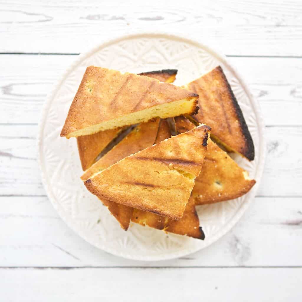 Grilled cornbread on a plate.