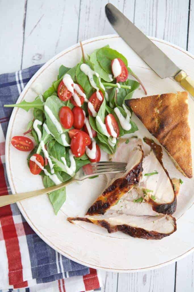 Grilled turkey breast plated with salad