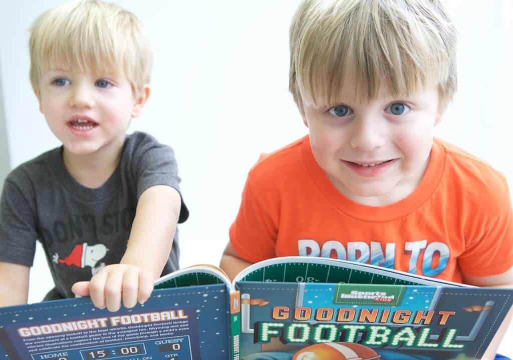 kids reading football board book at bedtime