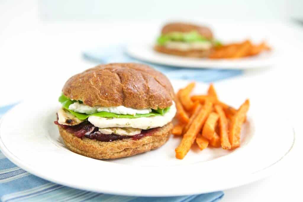 Turkey cranberry sandwich plated with sweet potato fries