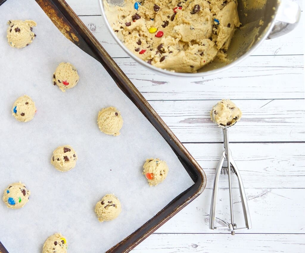 the best chewy chocolate chip cookie dough with a scoop on a baking sheet