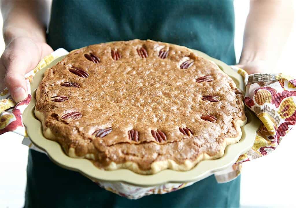 person holding pie fresh from the oven