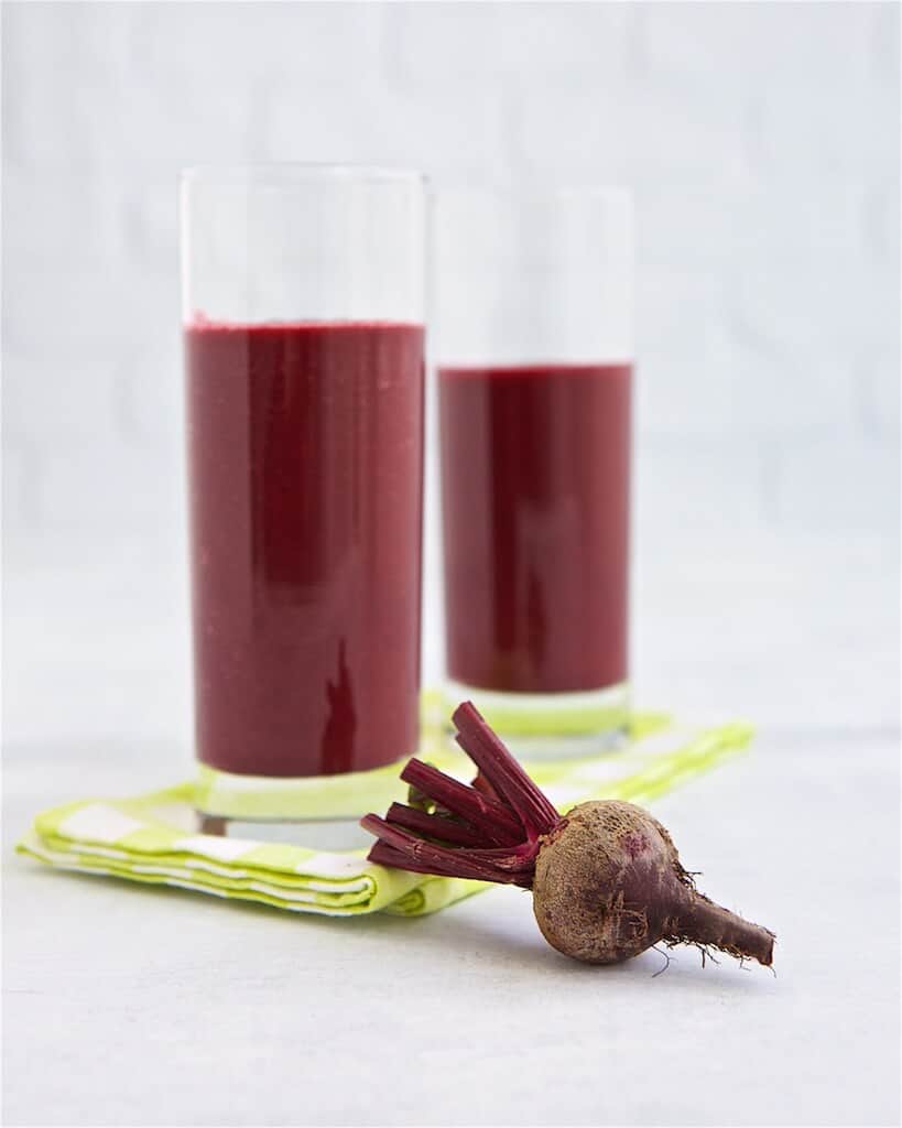 mango beet breakfast smoothie in two glasses