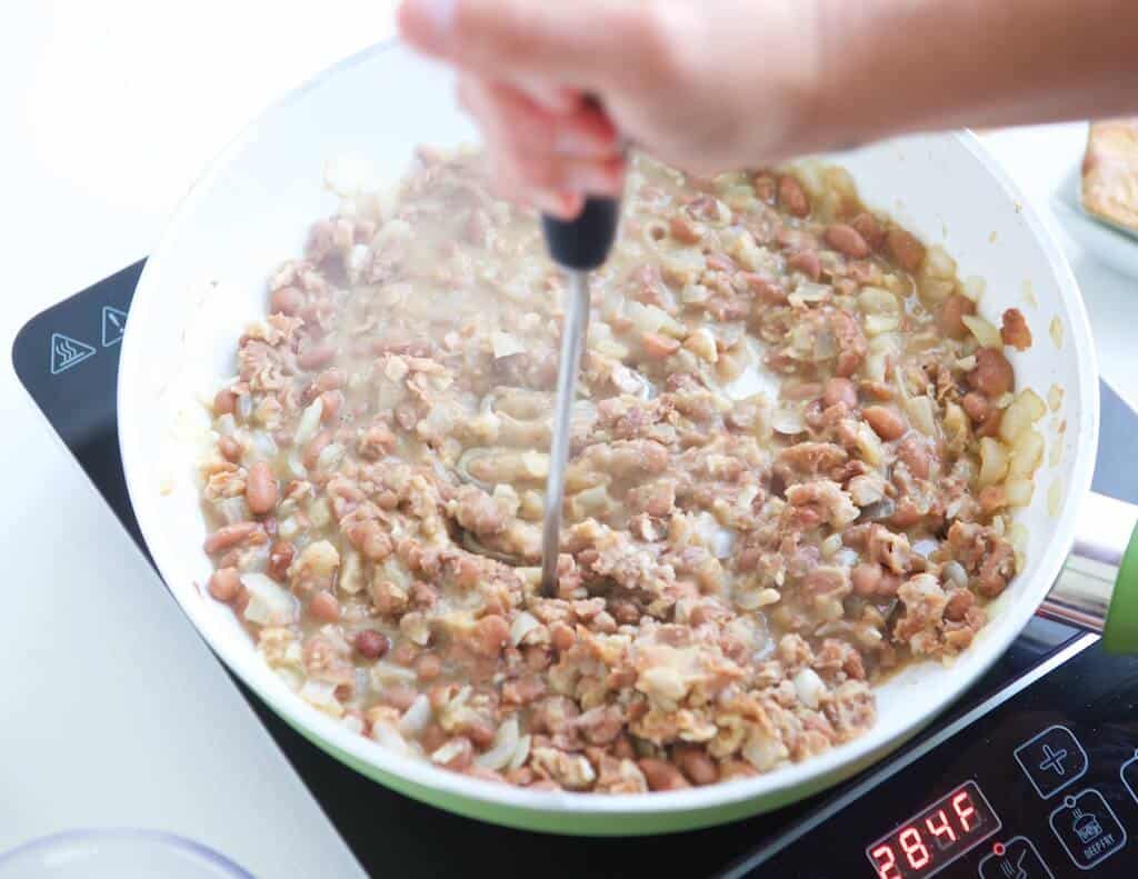 Using a potato masher.