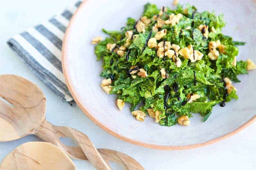 avocado kale salad with salad tongs