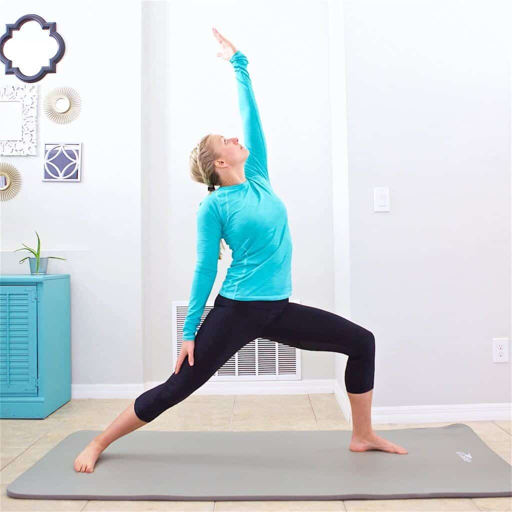 woman doing yoga pose as a part of her home workout schedule