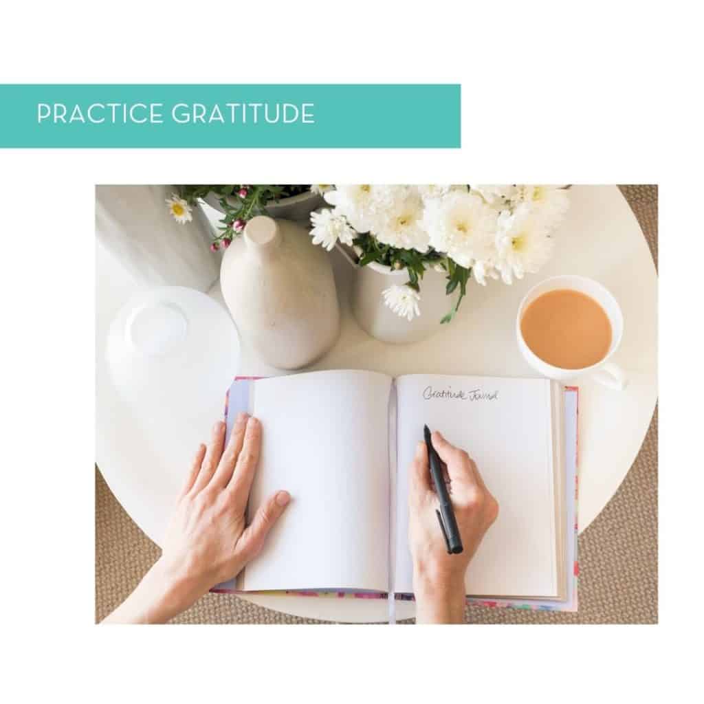 Hands journaling a gratitude list