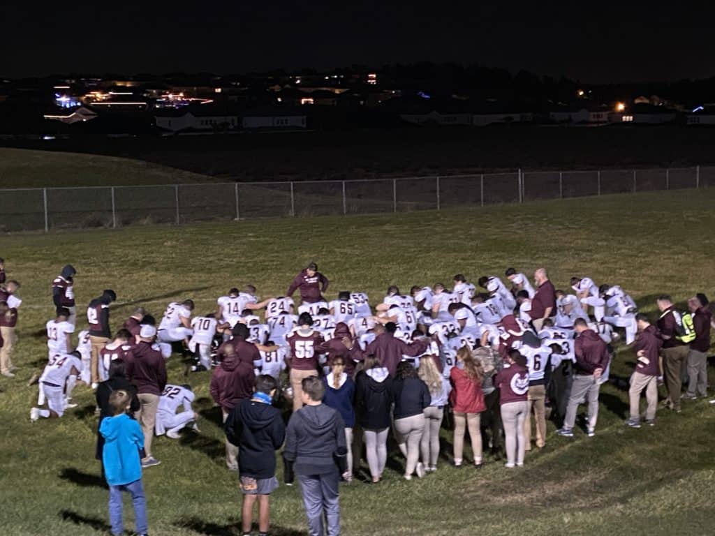 the end of the season - football team huddle after game