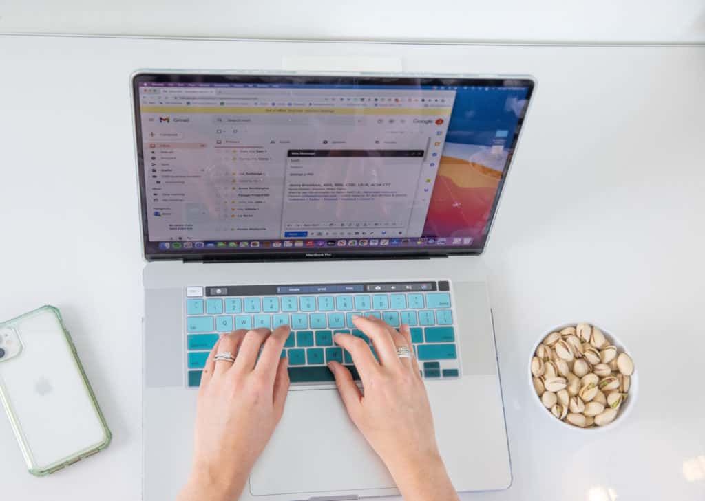 woman at work with a small bowl of pistachios 