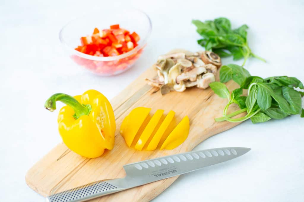 vegetables on a cutting board that are ingredients for beef veggie skillet