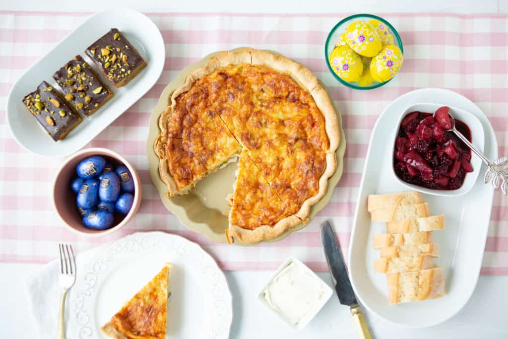 Easter Brunch Ideas - Overhead shot of quiche, berry compote and pistachio blonde brownies on table.