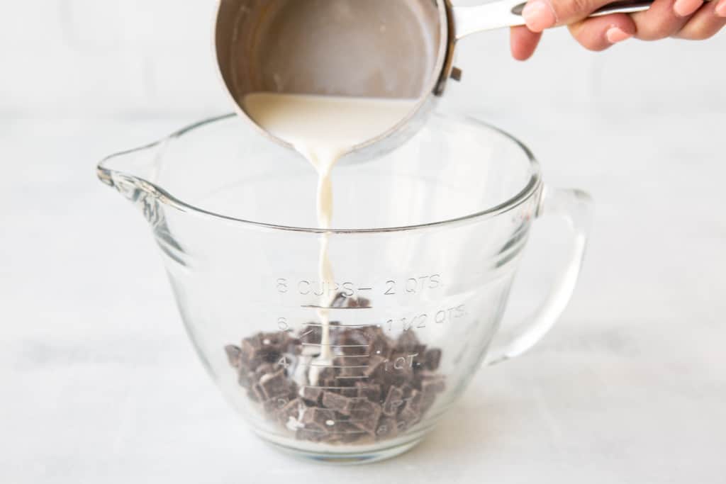 Pouring hot cream over chocolate to make ganache.