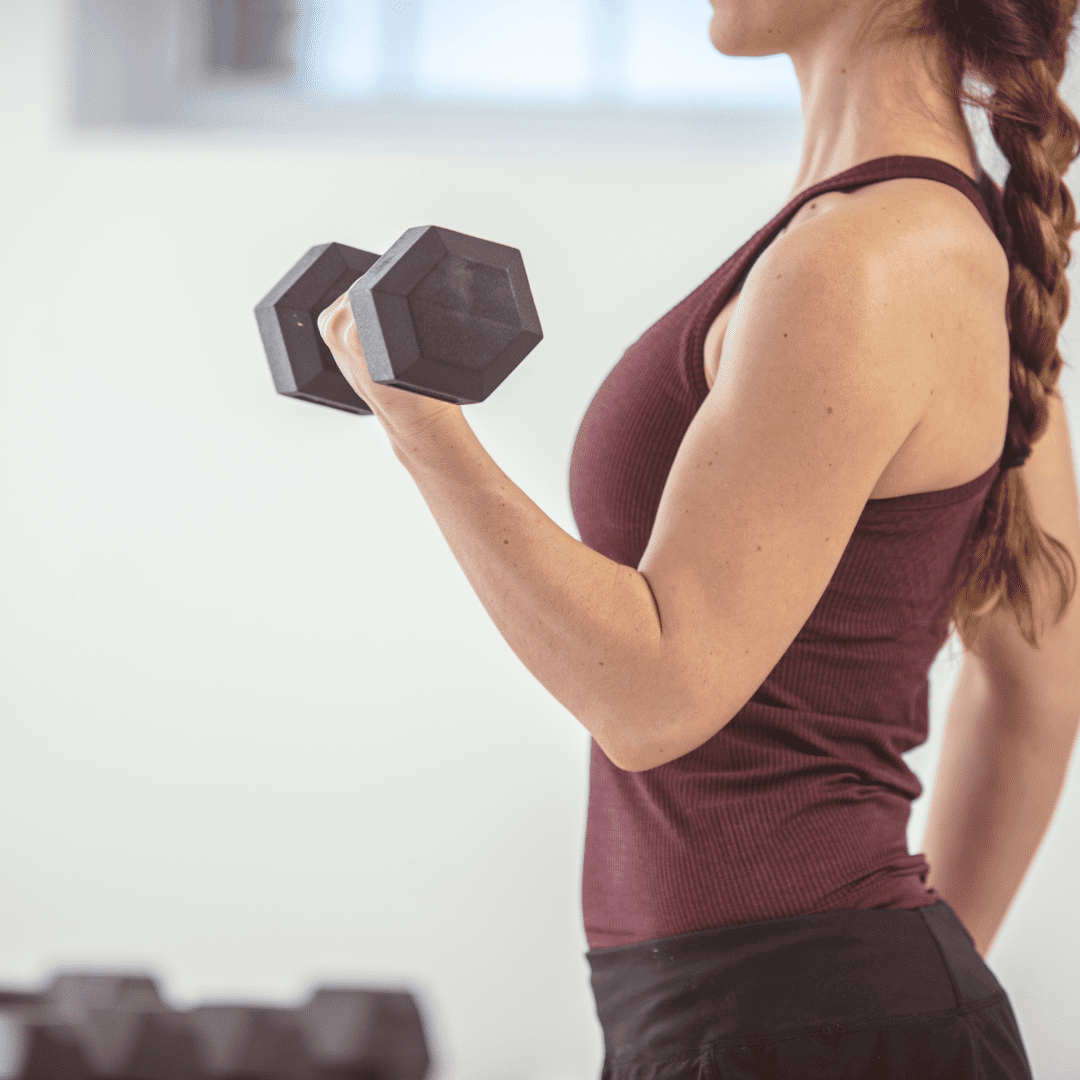 women doing a bicep curl with a dumbell