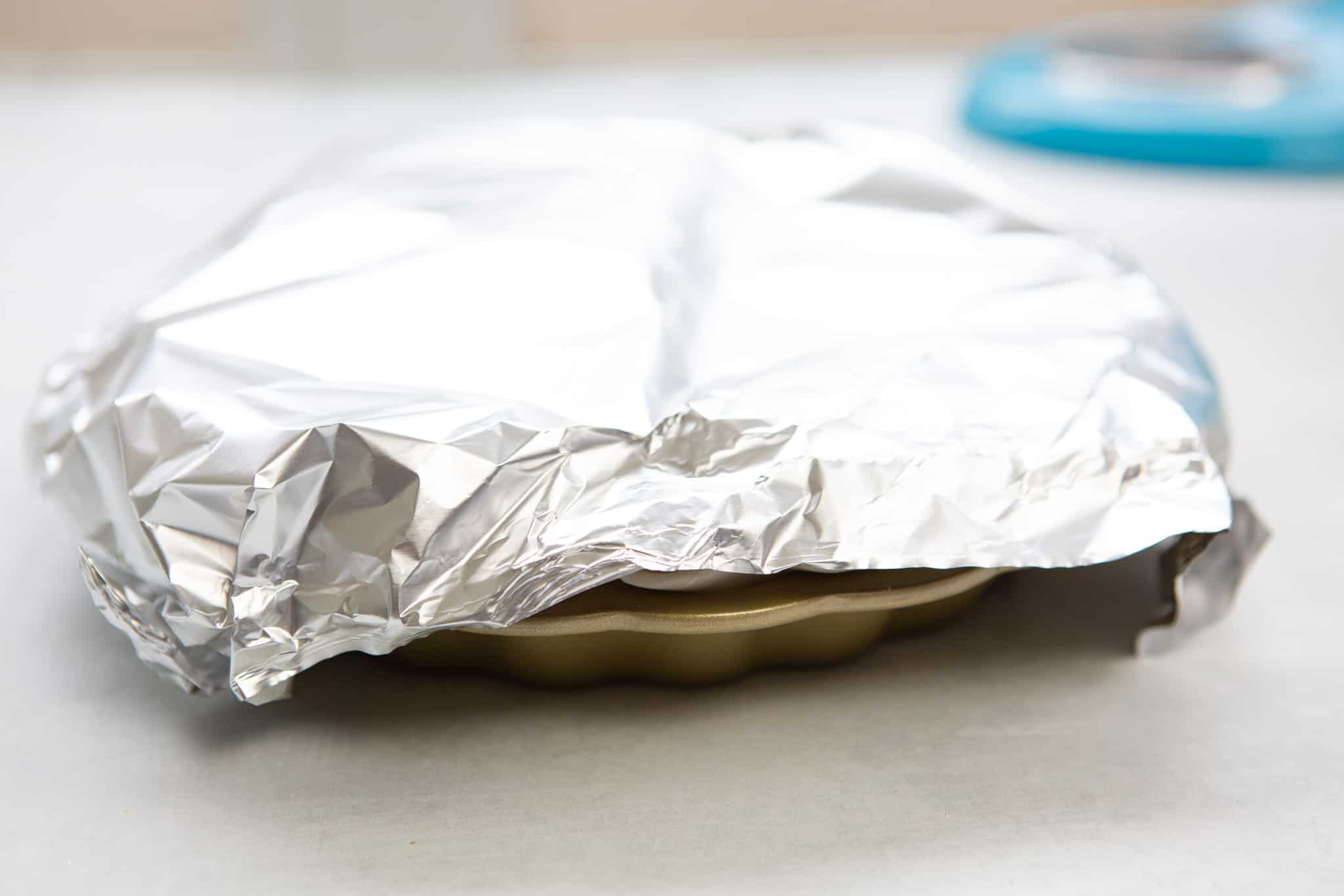 Prepared pie loosely covered with aluminum foil and ready to go into the oven.