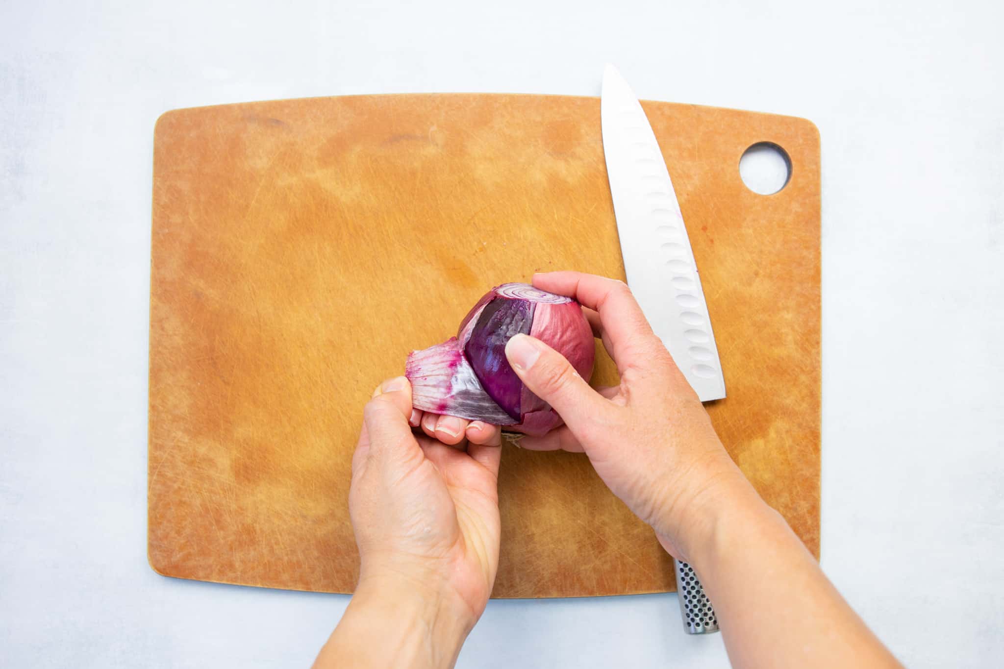 pull off dry outer layers of the onion 