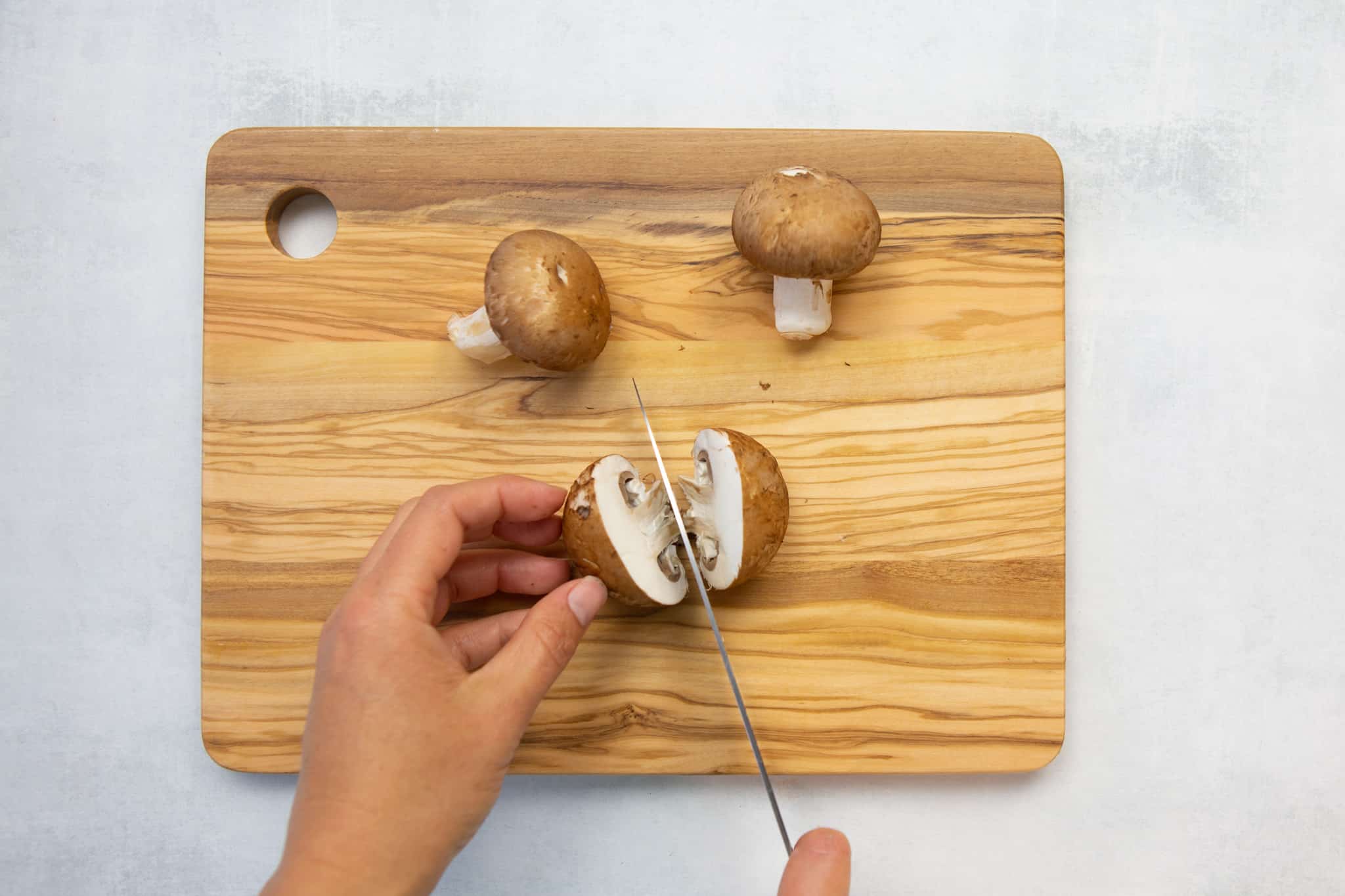 slice mushrooms in half