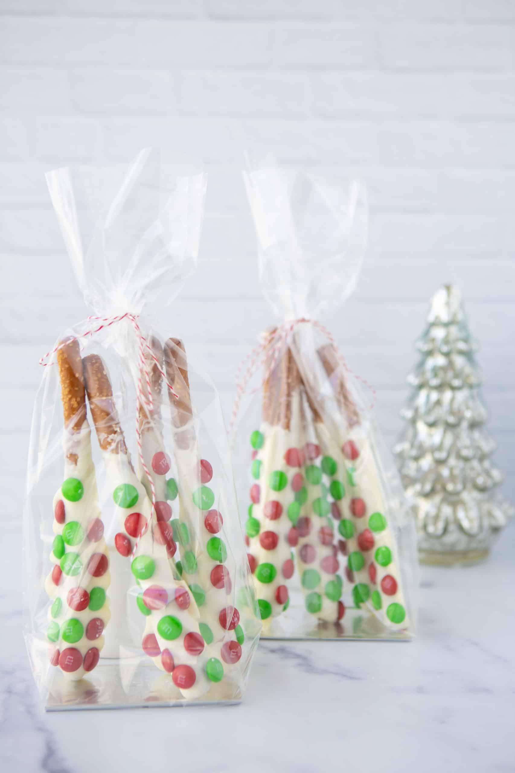pretzel rods with christmas m&ms in a cellophane bag for gifting