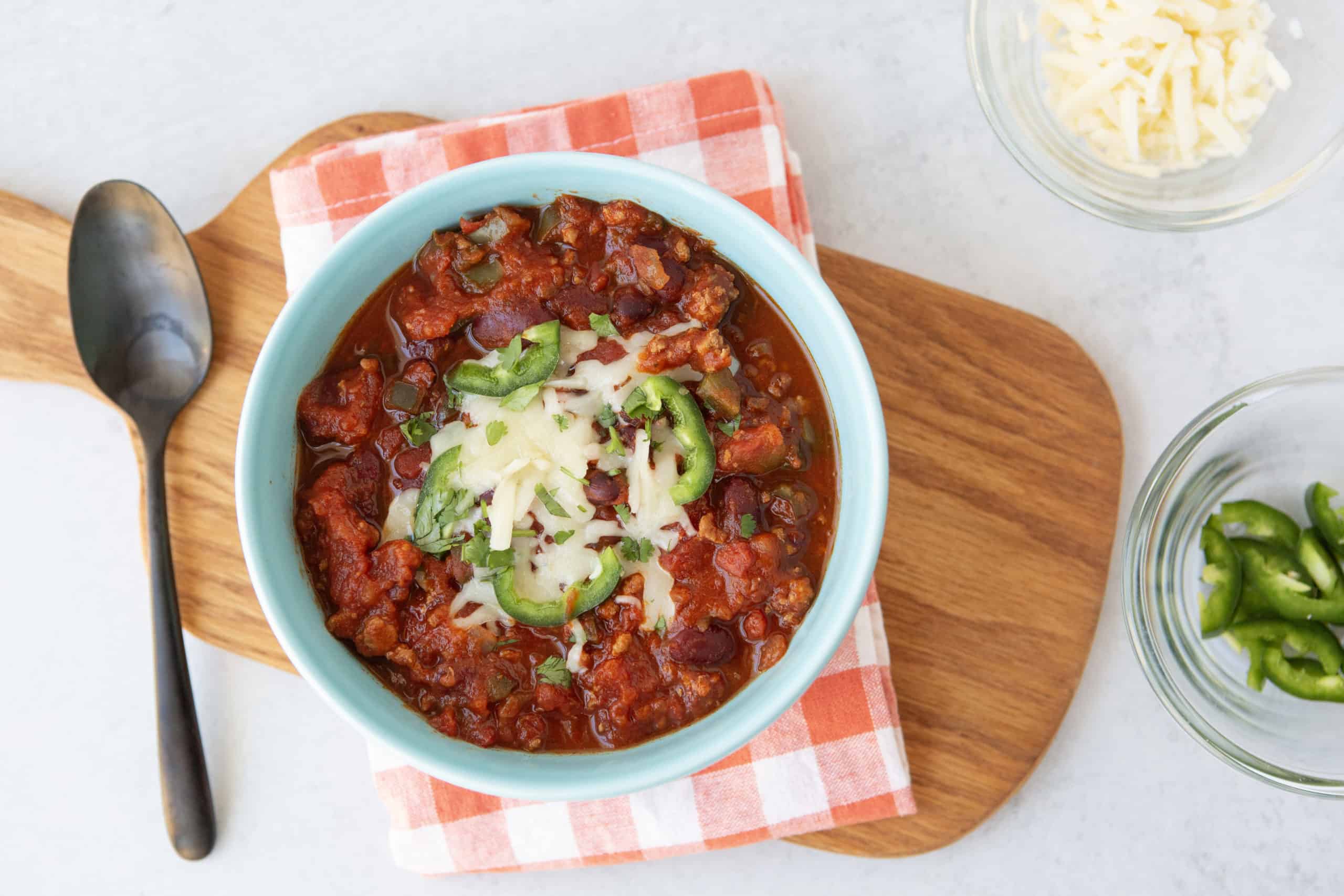 Easy Instant Pot Turkey Chili with cheese and jalapeno toppings
