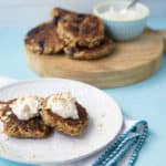 oatmeal griddle cakes on a plate with whipped honey ricotta topping