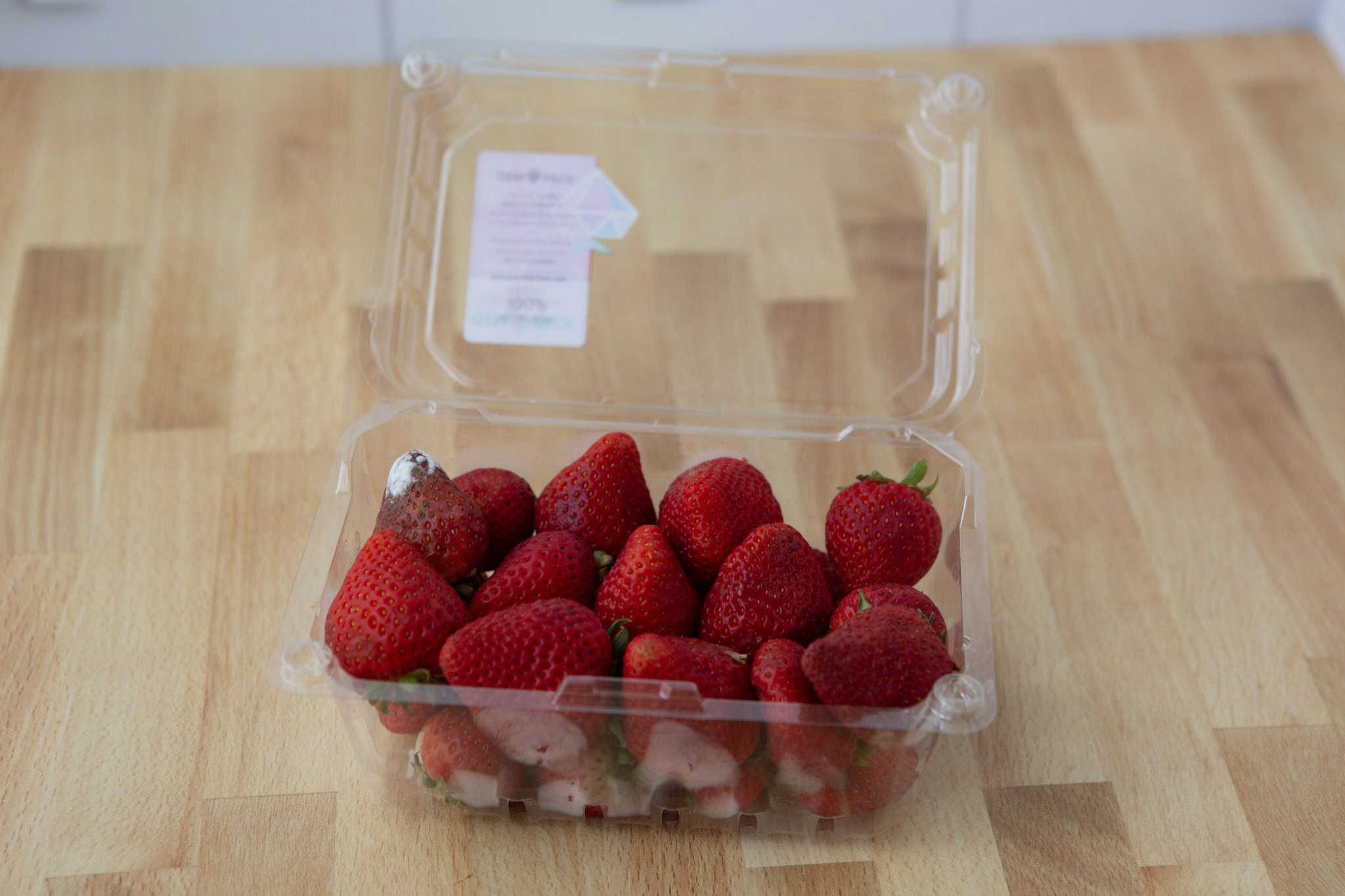 moldy strawberries in plastic container