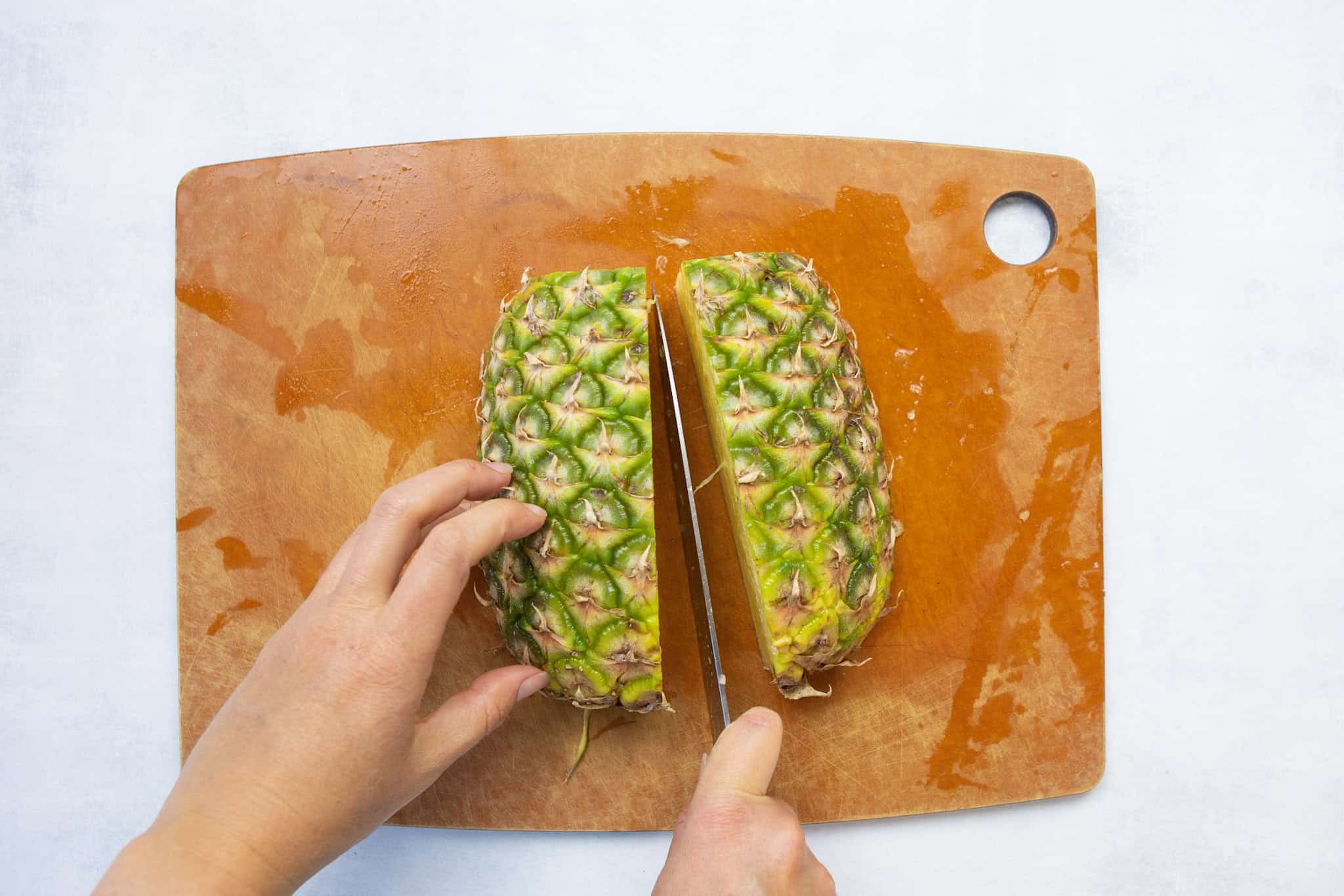 slicing pineapple to store in the freezer to prevent spoilage