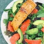 salmon on a bed of lettuce with avocado