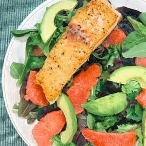 salmon on a bed of lettuce with avocado